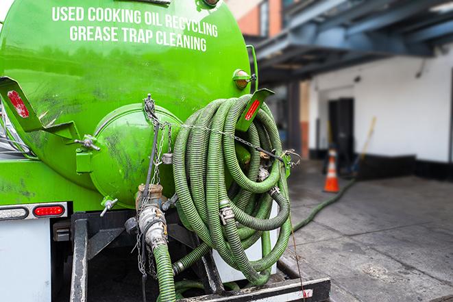 a large grease trap being pumped by a specialist in Empire CA